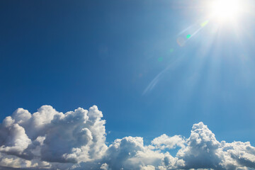 Blue sky with sun and clouds