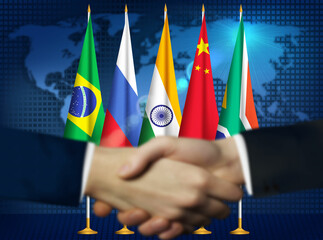 Two person shaking hands in front BRICS countries flags.Brazilian,Russian,Indian,Chinese,South African flags together - obrazy, fototapety, plakaty