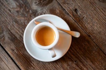 Pverhead shot of a cup of espresso coffee on a wooden restaurant table, Brussels city, Belgium