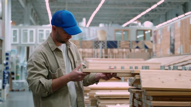 Carpenter selecting wood in a hardware store. 