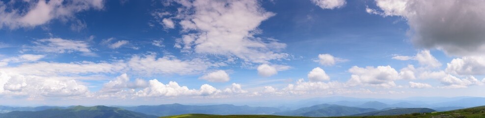 gorgeous panorama of a blue sky with fluffy clouds. amazing cloudscape above the mountain range on a sunny weather in summer