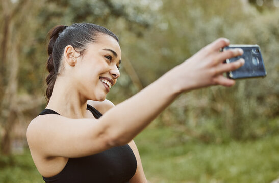 Happy woman, fitness and smile in nature for selfie, photography or outdoor memory and exercise. Active or sporty female person taking photograph, picture or online social media vlog after workout