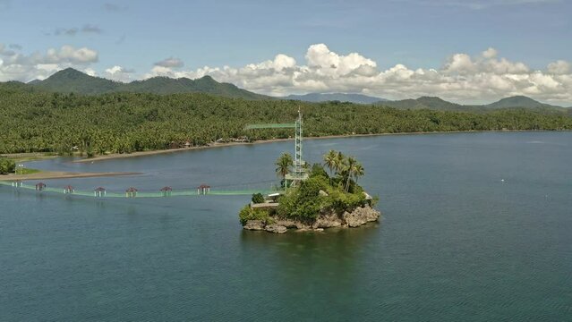 Point of interest drone view of Bacuag Hanging Bridge and Octopus Islet. Adventure Zipline attraction located in Bacuag, Surigao Del Norte. Philippines.