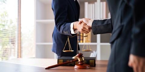 Businessman shaking hands to seal a deal with his partner deal lawyer or attorney discussing a...