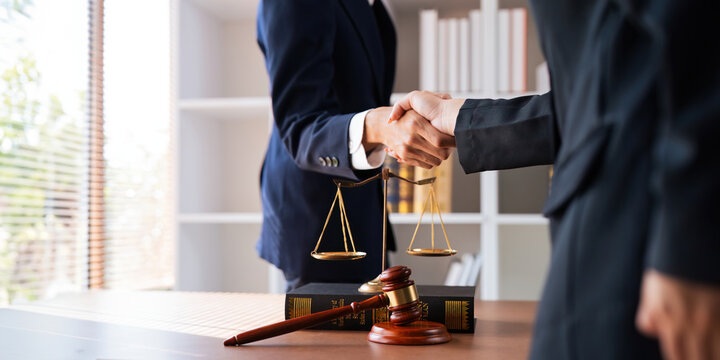 Businessman shaking hands to seal a deal with his partner deal lawyer or attorney discussing a contract agreement. legal, lawyer, real estate, justice concept