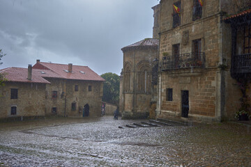 Downpour. Strong storm with abundant rain over the Plaza de las Arenas in Santillana del Mar - obrazy, fototapety, plakaty