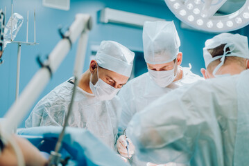 A highly qualified team of surgeons performs a complex operation to remove a pancreatic cyst using medical instruments