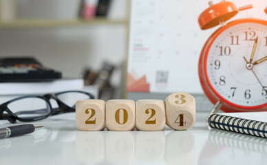 2024 new year idea concept. 2024 text on wooden blocks with data analysis and office concept...