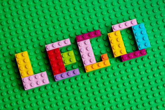 Smolensk - September 21, 2023: Letters with Lego text made from Lego bricks on a green Lego base plate.