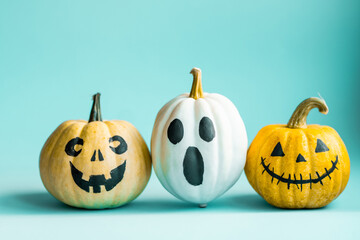 Beautiful jack o lantern pumpkin on a blue background.Creative halloween concept backdrop.Kids halloween pumpkin craft.