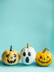 Beautiful jack o lantern pumpkin on a blue background.Creative halloween concept backdrop.Kids halloween pumpkin craft.