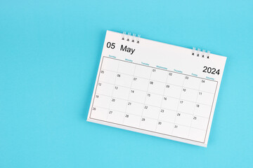 The May 2024, Monthly desk calendar for 2024 year on blue color background. - obrazy, fototapety, plakaty