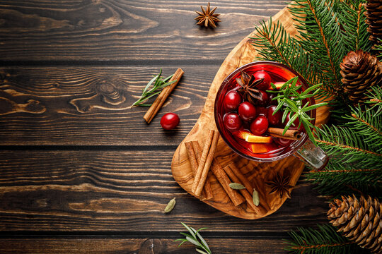 Christmas mulled wine with cranberry, orange, cinnamon, anise and rosemary. Traditional hot drink or beverage, festive Xmas or New Year winter cocktail