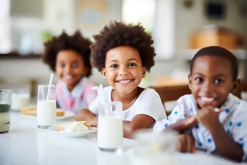 Muurstickers African American children happily drinking milk in class © Elaine