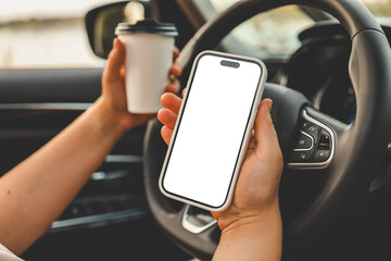 A phone with an isolated screen in the hands of a woman in a car