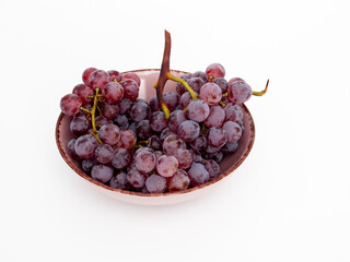 Red grapes on a white background. Ripe grapes close-up.