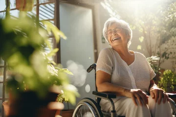 Foto op Canvas Senior woman in wheelchair happily laughing.  Lifestyle portrait.  © SalenayaAlena