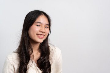 Happy cheerful young Asian girl with long light hair smiling brightly feeling happy with a positive expression, joyful surprise funky, Female in black with a big smile isolated on white background.