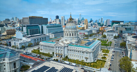 Aerial of city hall with solar panels on government building roof and distant city
