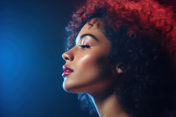 Profile of biracial woman with curly hair in blue and red light - obrazy, fototapety, plakaty