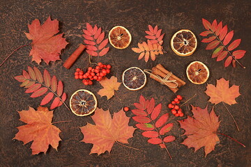 Autumn abstract composition with maple leaves, dried fruits, oranges and rowan berries, still life, Thanksgiving concept, seasonal background, banner or screensaver, greeting card or invitation,