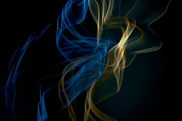 Abstract photography, blue and gold curved lines on a black background, made with intentional...