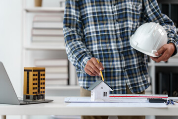 Architect engineer drawing plan blueprint of condominium or apartment tower building