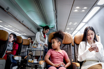 Happy African girl child and woman passenger sit in comfortable seat inside airplane during female...