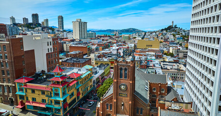 View of Chinatown from drone aerial with distant San Francisco Bay and Coit Tower