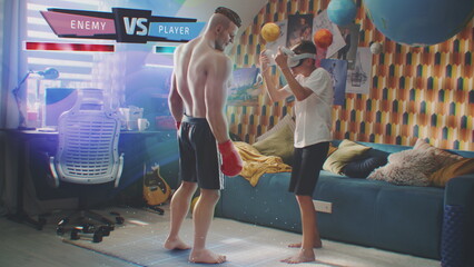 Boy in VR headset plays online augmented reality video game at home using wireless controllers. Young gamer fights with 3D graphics hologram of boxer. Futuristic VFX animation. Virtual gaming concept.