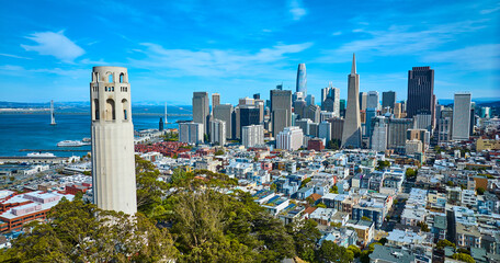 Aerial of San Francisco skyscrapers view from beside Coit Tower with distant Oakland Bay Bridge