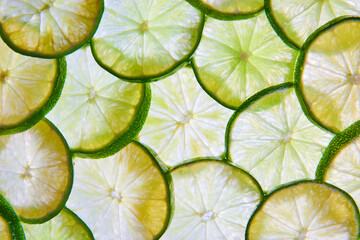 Wall of overlapping green lime slices in background asset of citrus fruit