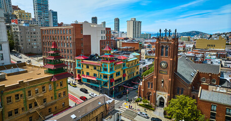 Colorful Chinatown buildings and church on blue sky day with partial clouds aerial