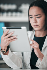 Tablet, pharmacy and confused Asian woman in laboratory for website, wellness app or telehealth. Healthcare, pharmaceutical and person on digital tech online for medical service, medicine or research