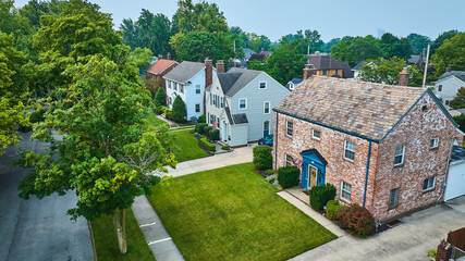 Aerial of houses off Pemberton Dr with old brick building and neatly trimmed green lawns
