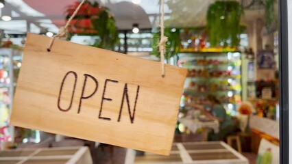 The open sign on the door of the cafe and restaurant moved back and forth.
