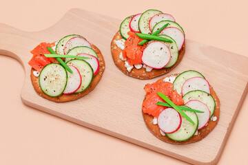 Crispy Cracker Sandwiches with Fresh Salmon, Cucumber, Radish, Cottage Cheese and Green Onions. Easy Breakfast. Quick and Healthy Sandwiches. Crispbread with Tasty Filling. Healthy Dietary Snack