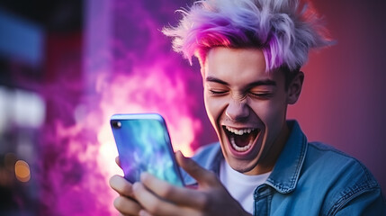 Happy young man with colored hair colorful clothes and a smart mobile phone in his hands laughs and screams with joy while looking at the device screen