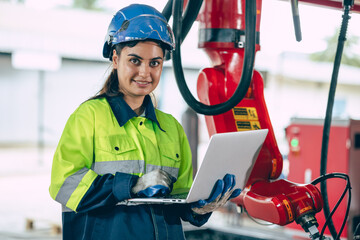 Portrait Indian young smart engineer woman worker confident look with safety suit work in advance technology industry