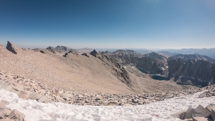 Panorama view on tops of mountains with snow remnants and blue sky in Sierra Nevada, America