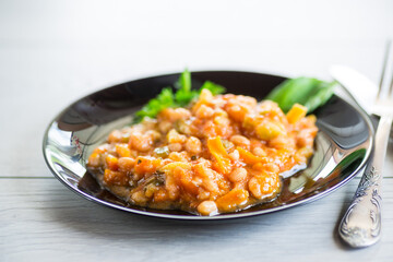 Cooked white beans with zucchini and other vegetables.