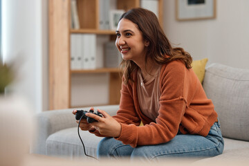 Happy woman, sofa and playing video games in relax or free time in living room for entertainment at...