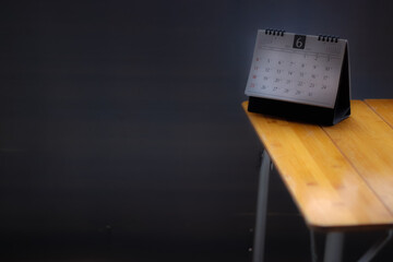 Blurred calendar page in planning concept.Black background. For entering text, year 2023, month 6