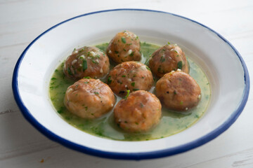 Salmon meatballs with green parsley sauce. Traditional Spanish tapa recipe.