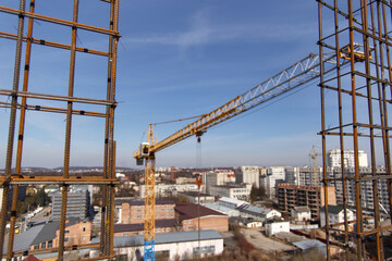 Fototapeta na wymiar A construction crane during work at a construction site