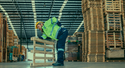 A wood factory worker's muscle injury from lifting heavy workpieces, worsened by slippery floors.
