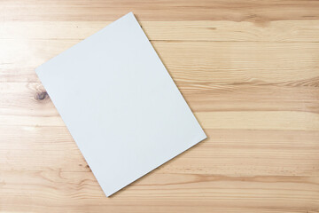 Mockup of blank book cover white on textured wooden background. 
Empty magazine template to your...