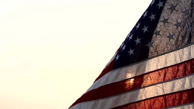 Happy Veterans Day. American USA flag waving against sun in the sky, federal holiday in the United States on November 11, for honoring military veterans of USA Armed Forces. Concept of Veterans Day