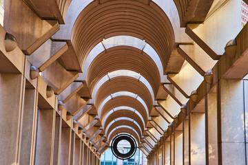 Symmetrical and optical illusion ceiling with curving openings with tunnel view to black opening