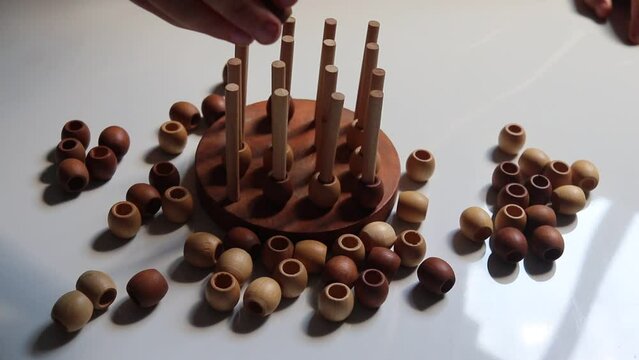logic wooden board game and a boy playing with it close-up